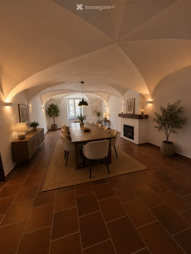 Elegant dining room with exposed wooden beams, terracotta tiles, a long wooden dining table surrounded by chairs, a fireplace, sideboard, table lamps, and potted plants.