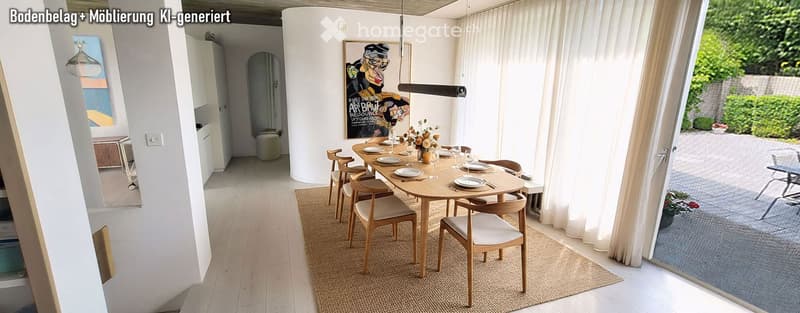 Bright dining area with a round wooden table surrounded by six chairs, a vase with flowers, and a large picture frame on the wall. The space features light wooden flooring, white walls, and large windows with sheer curtains.