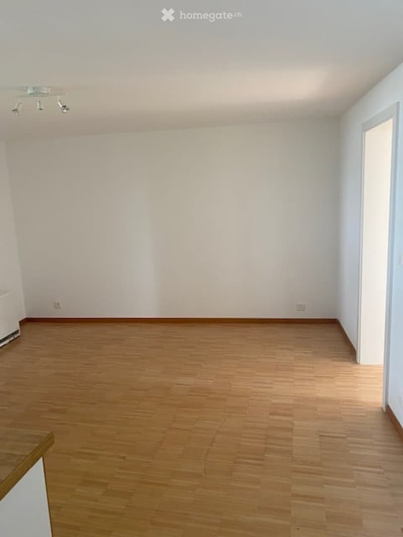 Completely empty room with wooden flooring and white walls. No furniture or equipment present.