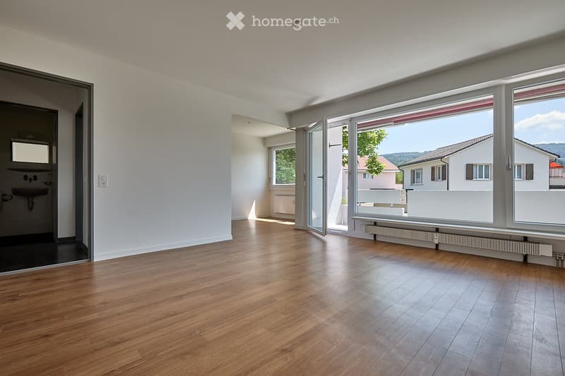 large windows, balcony, hardwood floors, modern bathroom with sink and mirror