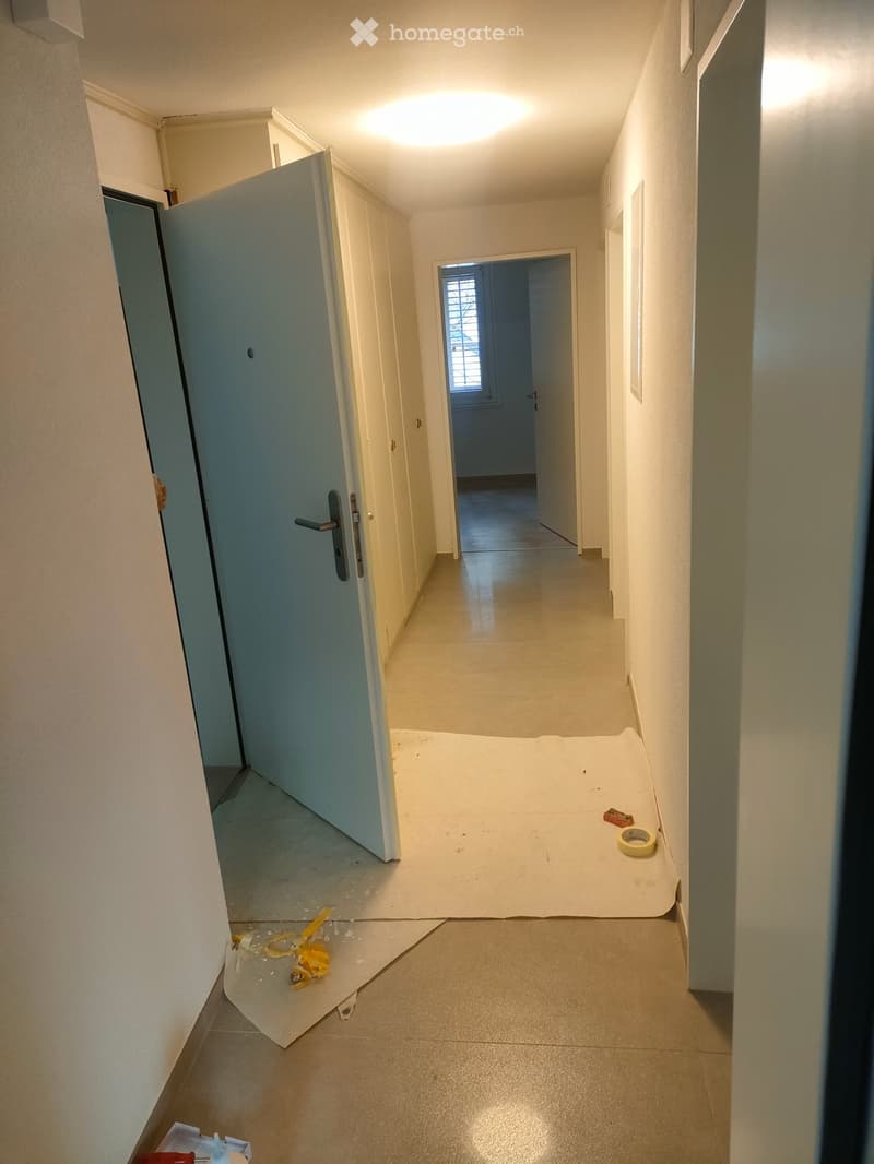 Tiled floor, open doorways, narrow hallway