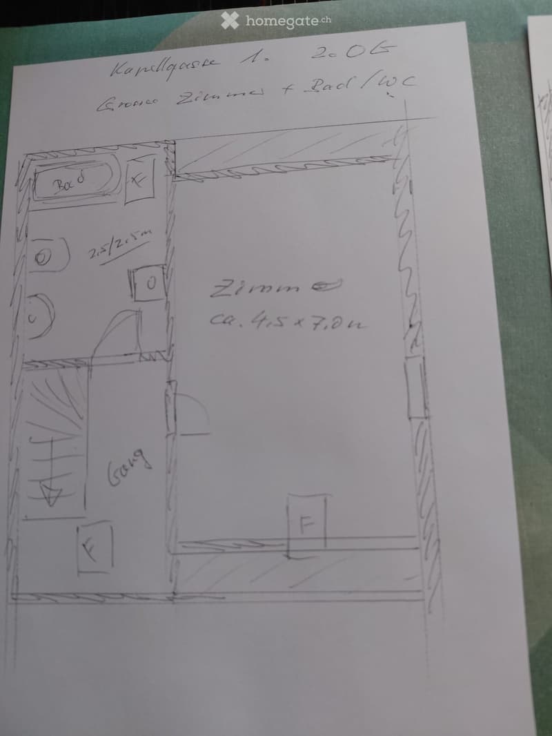 Hand-drawn floor plan showing a living room, two bedrooms, and a bathroom.