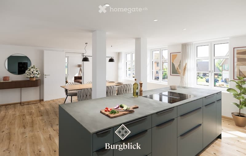 Modern kitchen with island, grey cabinets, wooden floor, large windows, and various kitchen items on the island.