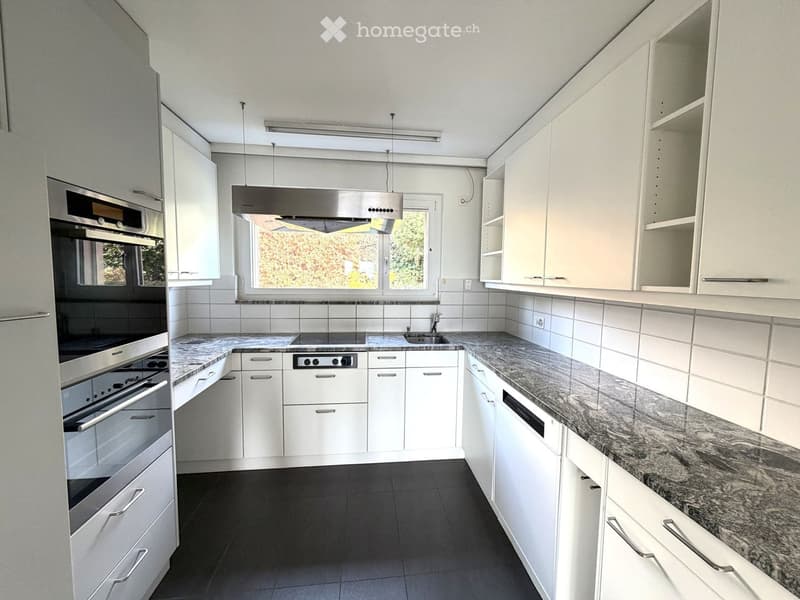 modern white kitchen with granite countertops, built-in oven, dishwasher, electric hob, fridge, and extractor hood