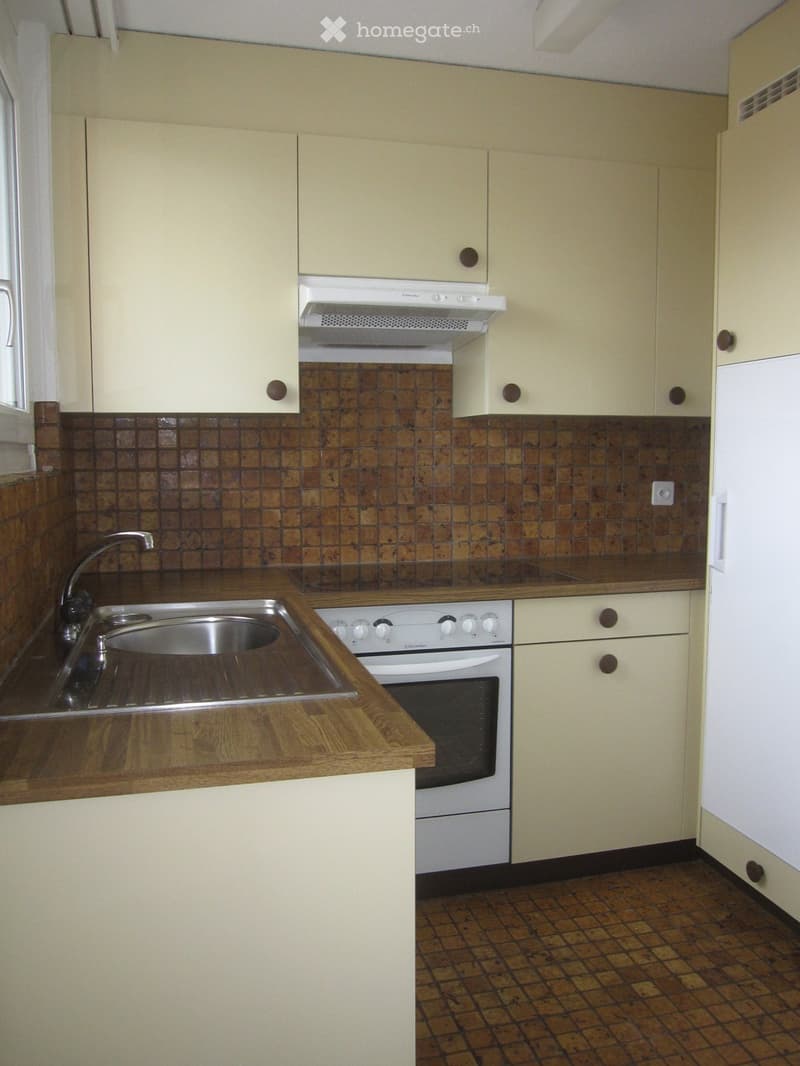 kitchen with white appliances, wooden countertops, tiled backsplash, beige cabinets, stainless steel sink, and a window