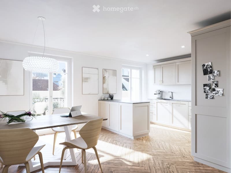 Bright, modern kitchen and dining area with white cabinets, wooden dining table, four chairs, laptop, coffee machine, and a large window with a view of the city.