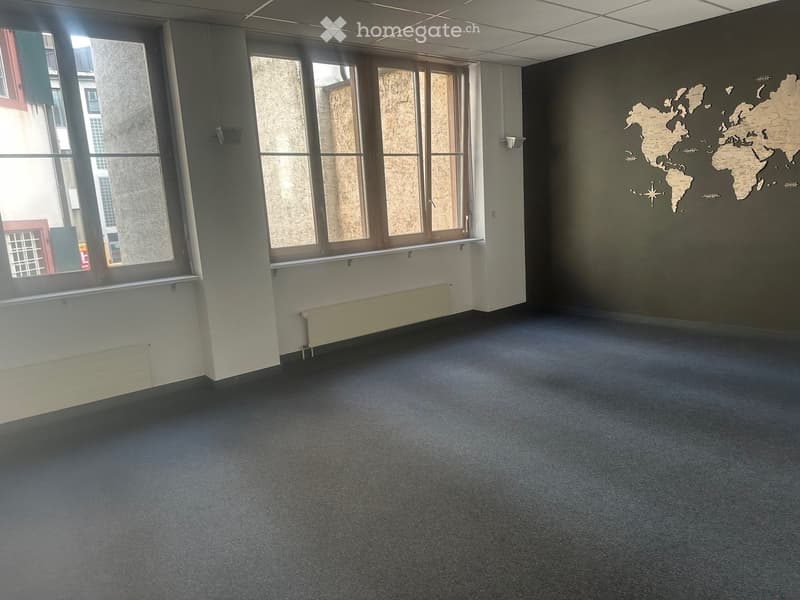 empty room with radiators and large windows