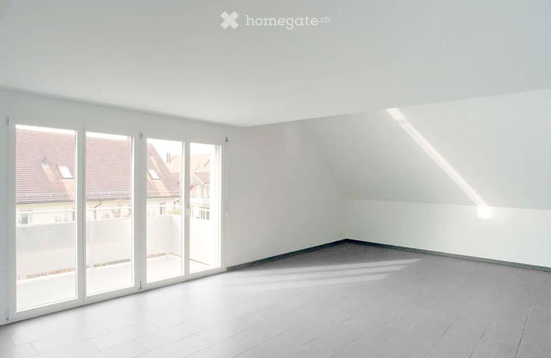 Empty room with white walls, large sliding glass doors, and a tiled floor. No furniture or equipment present.
