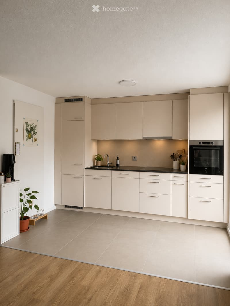 Modern kitchen with light-colored cabinets, stainless steel appliances, and a black countertop. Features include a sink, faucet, oven, and various kitchen utensils.