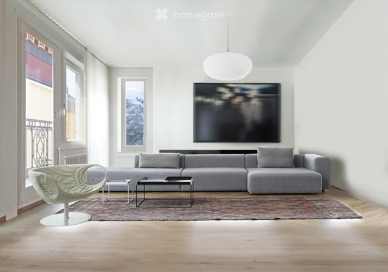 Modern living room with a grey sectional sofa, white pendant light, coffee table, side tables, and a decorative rug on a wooden floor.