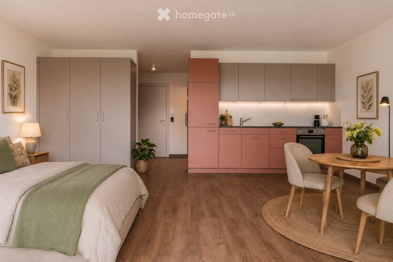 A modern, open-plan living space featuring a bedroom area with a bed, a kitchen area with cabinets and appliances, and a dining area with a table and chairs. The room has wooden flooring, neutral-colored walls, and contemporary decor including framed artw