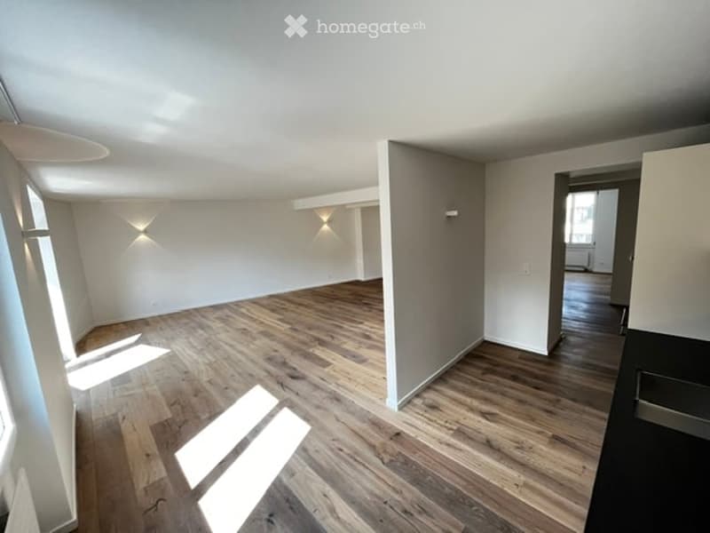 Empty room with wooden flooring, white walls, and built-in lighting. No furniture or equipment present.