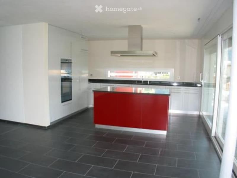 modern kitchen with white and red cabinets, central island, large windows