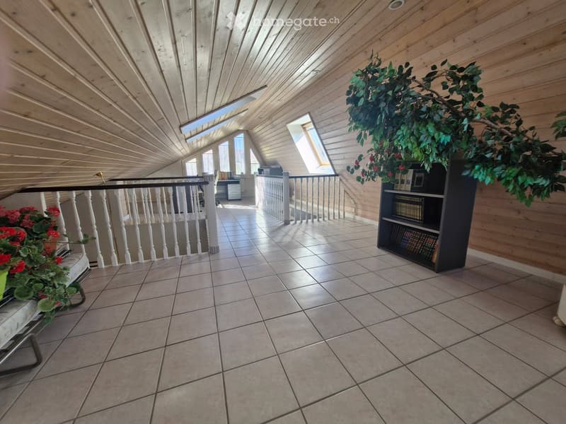 wooden ceiling, tiled floor, white railings, wooden walls, bookshelves, plants, flowers