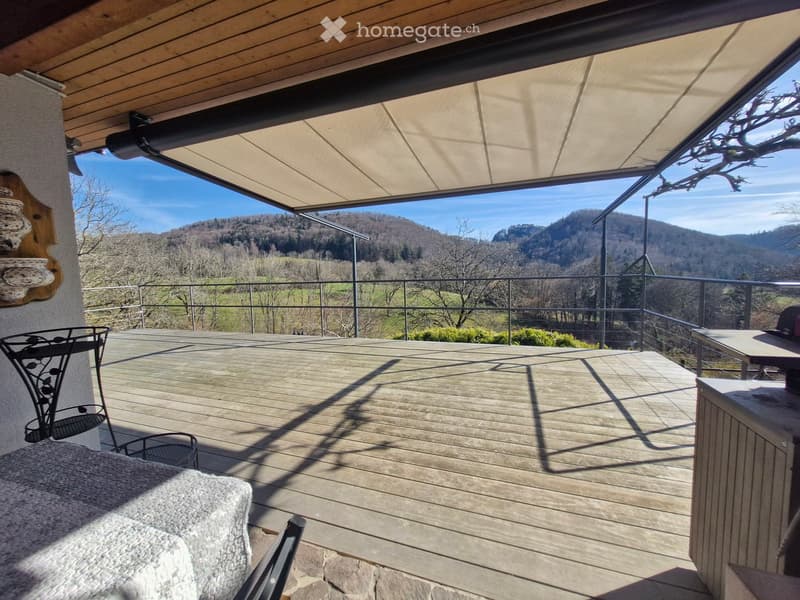 wooden deck, metal railing, retractable awning, table, chairs, scenic mountain view