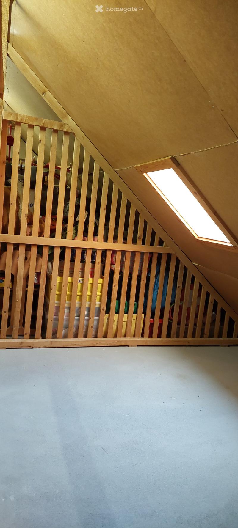 Wooden beams, ceiling light, toys, storage boxes, and various items stored
