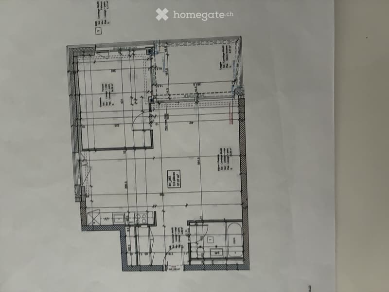 Floor plan of a residential building showing multiple rooms including living room, kitchen, bedrooms, bathrooms, and a balcony.