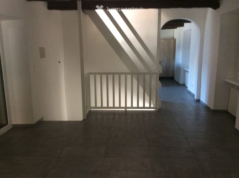tiled floor, white walls, staircase leading to upper floor, hallway