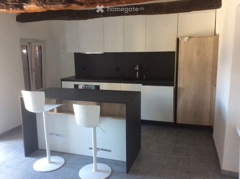 modern kitchen, white cabinets, black countertop, stainless steel faucet, white stools, dishwasher, washing machine