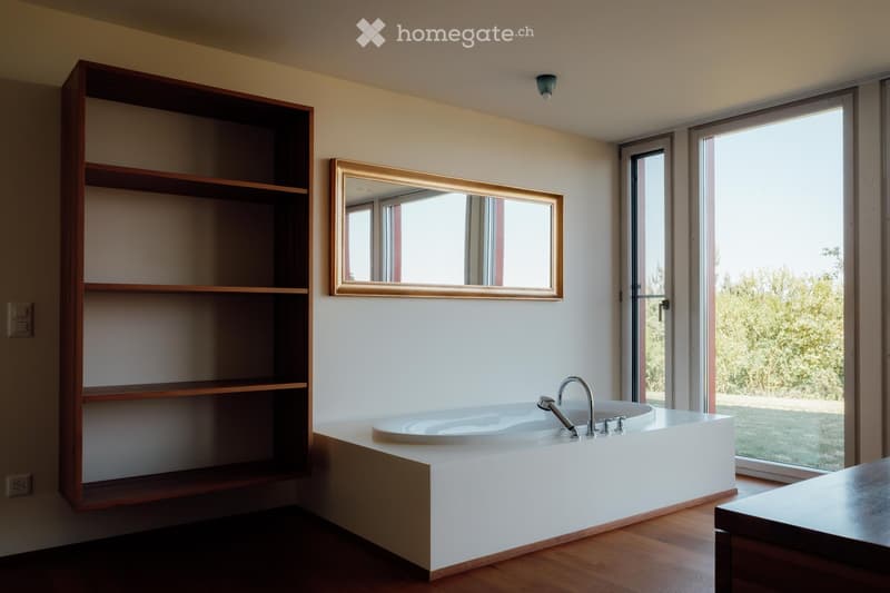 Bathroom with bathtub, wooden floor, large windows, wooden shelf, mirror