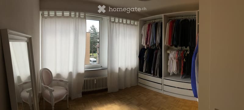 empty room, large window, white curtains, wooden floor, white radiator, large white wardrobe, pink chair