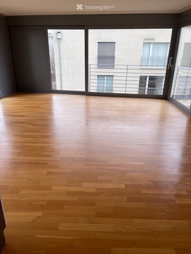 empty room with large windows and balcony
