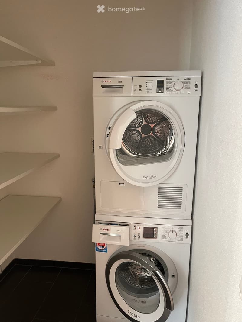 White Bosch washer and dryer stacked on top of each other