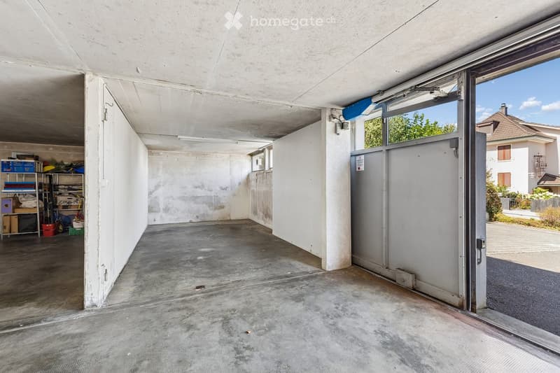 {"visible_features": ["Garage"], "type": "Garage", "objects": [], "description": "Empty garage with concrete floor, white walls, and a large open door leading outside. Shelves with storage items are visible on the left side.", "localized_descriptions": {"