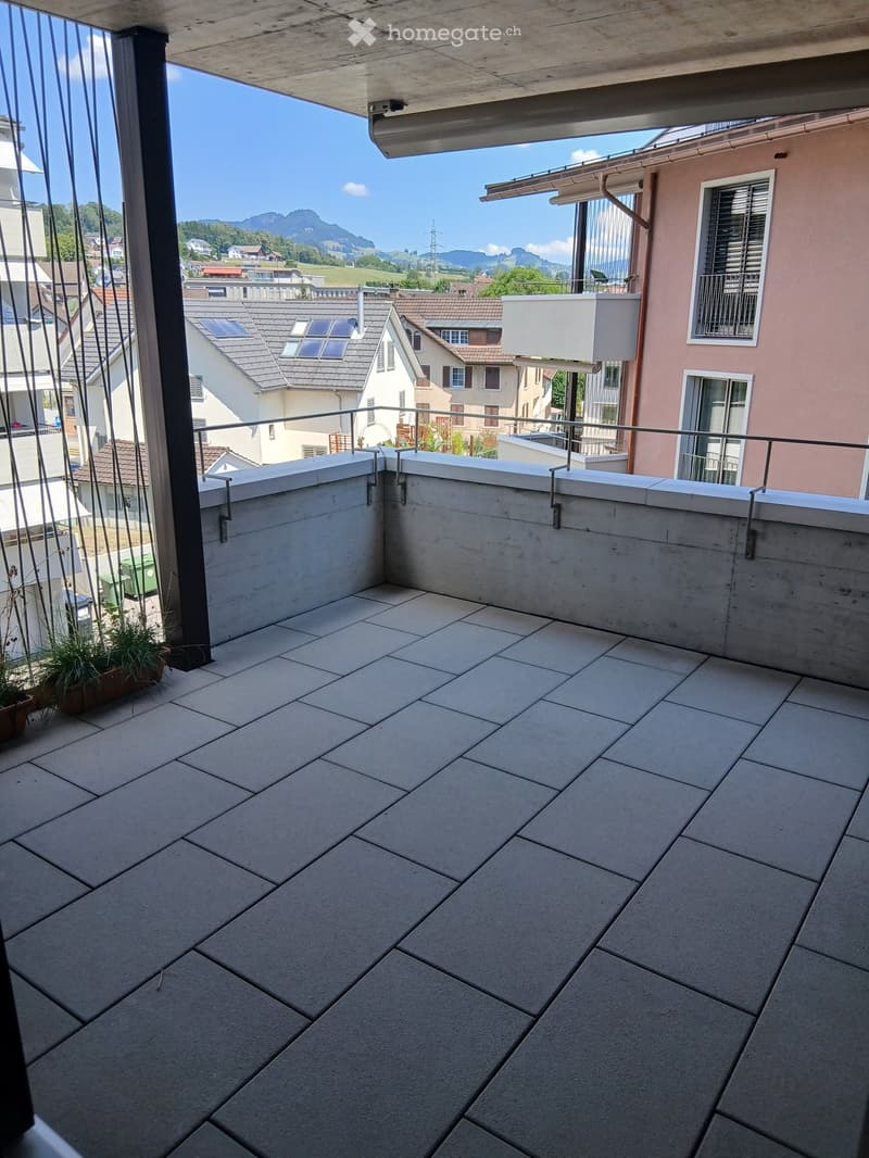 Balcony with tiled floor, metal railing, and scenic mountain view.