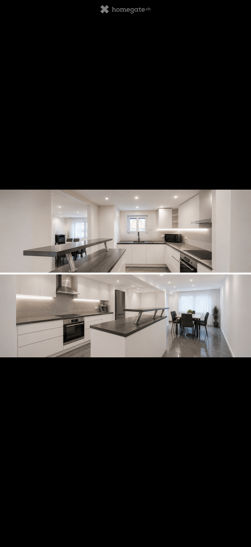Modern kitchen with white cabinets, black countertops, integrated appliances, and a dining area with a long table and chairs.