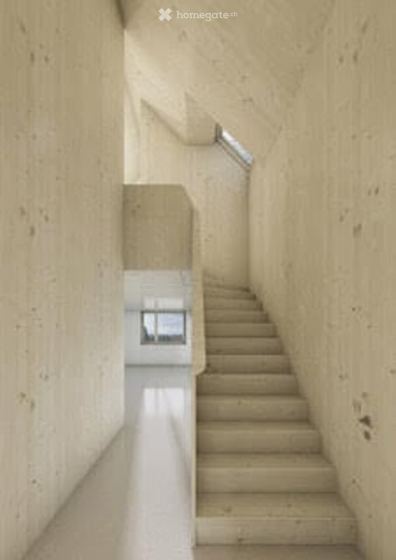 A modern, minimalist hallway with a staircase leading upwards, featuring clean lines and neutral tones.