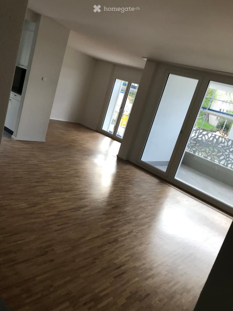 empty room, wooden floor, sliding doors to balcony, large windows, high ceiling