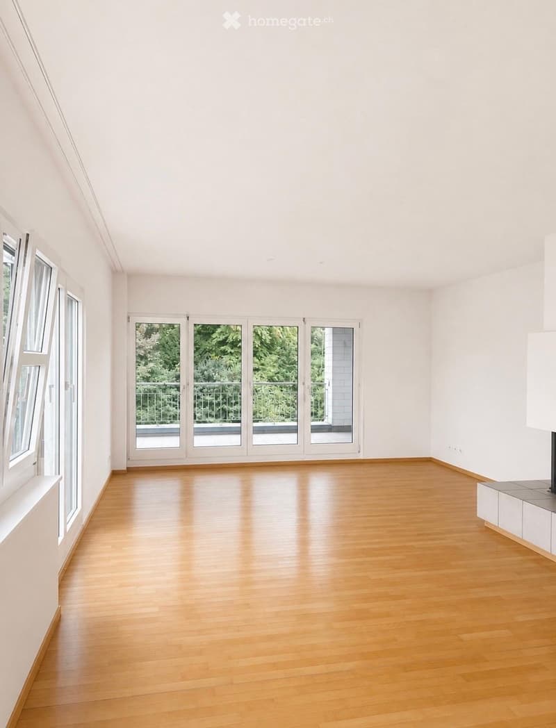 Empty room with light wooden flooring, white walls, large windows, and sliding glass doors leading to a balcony.