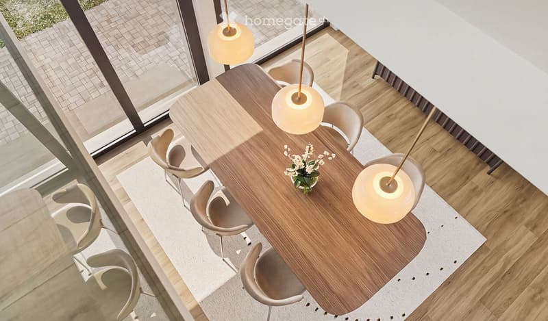 Modern dining area with a wooden dining table, six chairs, pendant lights, and a small flower arrangement in the center.