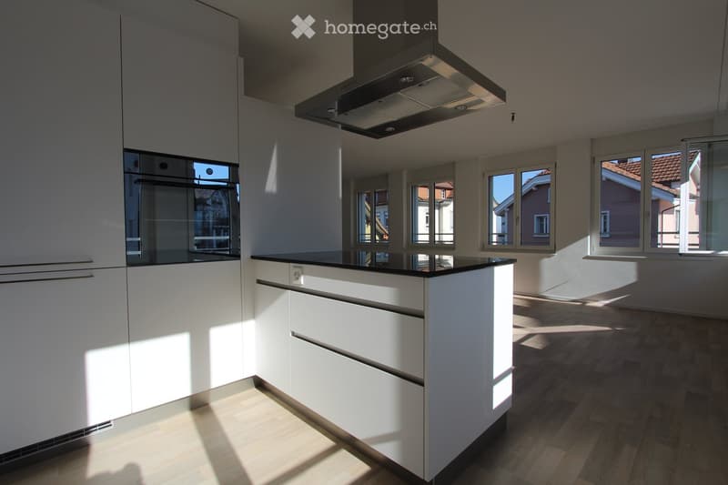 white cabinets, black countertops, stainless steel hood, wooden floor