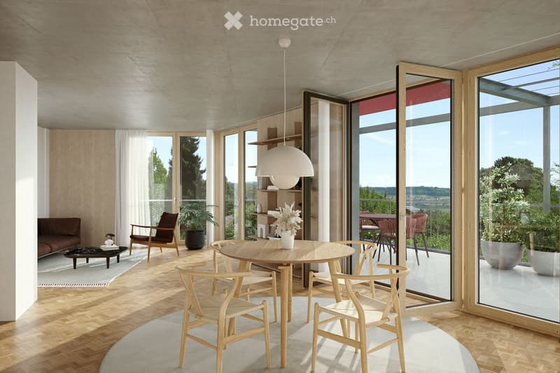 Modern living and dining area with wooden flooring, large windows, and a view of greenery. Features a sofa, coffee table, dining table with chairs, pendant light, and decorative plants.