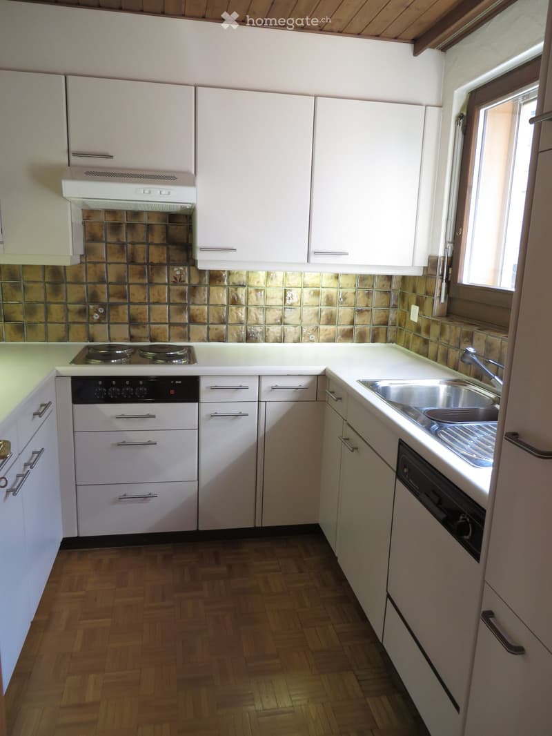 white cabinetry, white countertops, silver sink, gas stove, dishwasher, built-in oven, tiled backsplash, window