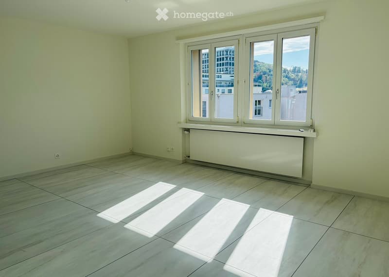 Empty room with light green walls, large windows, and a tiled floor. No furniture or equipment is present.
