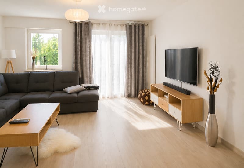 Modern living room with a grey sectional sofa, wooden coffee table, flat-screen TV on a wooden stand, floor lamp, and decorative vases.