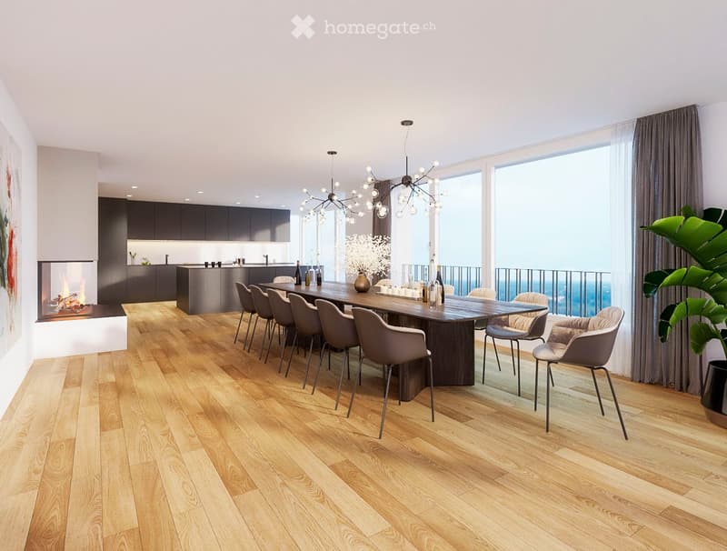 Modern dining area with a long wooden dining table, grey chairs, a fireplace, and a kitchen area with dark cabinets. Large windows offer a scenic view, complemented by a chandelier and decorative elements.