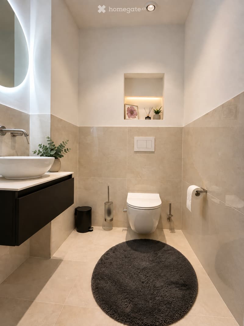 Modern bathroom with beige tiles, a white toilet, a black vanity with a sink, a round black rug, and a small shelf with decorative items.