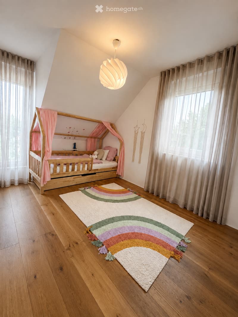 Cozy attic bedroom with wooden bed, pink curtains, colorful rug, and wall decorations.