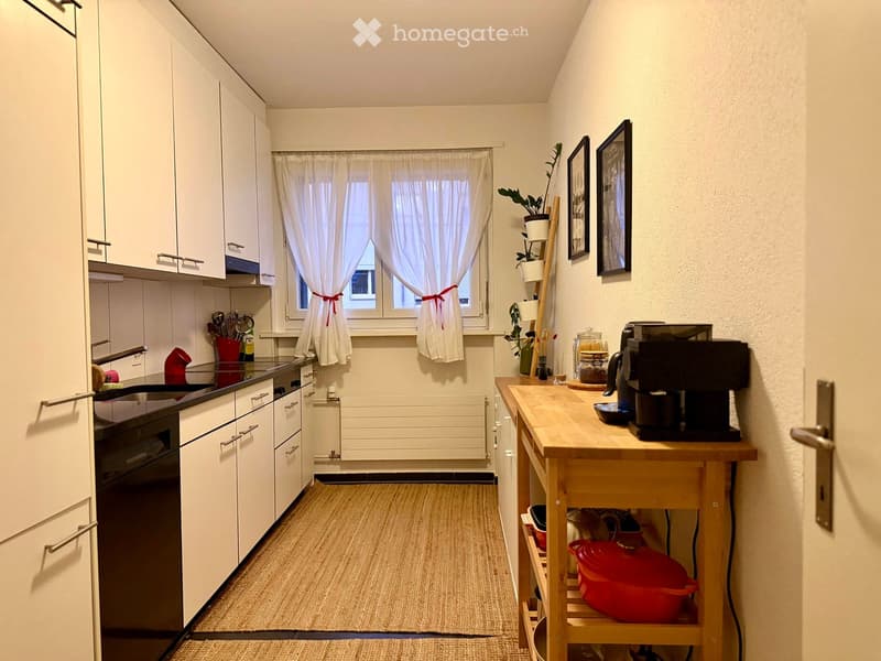 {"type": "Kitchen", "objects": ["cabinets", "sink", "oven", "coffee machine", "table", "framed pictures", "curtain", "plant", "cupboard", "cupboard", "cupboard", "cupboard", "cupboard", "cupboard", "cupboard", "cupboard", "cupboard", "cupboard", "cupboard