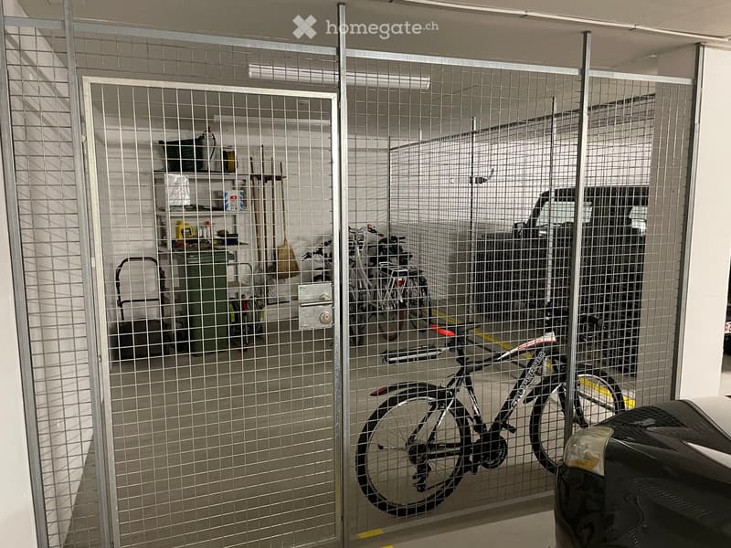 {"visible_features": ["Garage"], "type": "Garage", "objects": [], "description": "Garage with metal security gate, bicycles, and storage shelves with cleaning supplies.", "localized_descriptions": {"EN": "Garage with metal security gate, bicycles, and sto