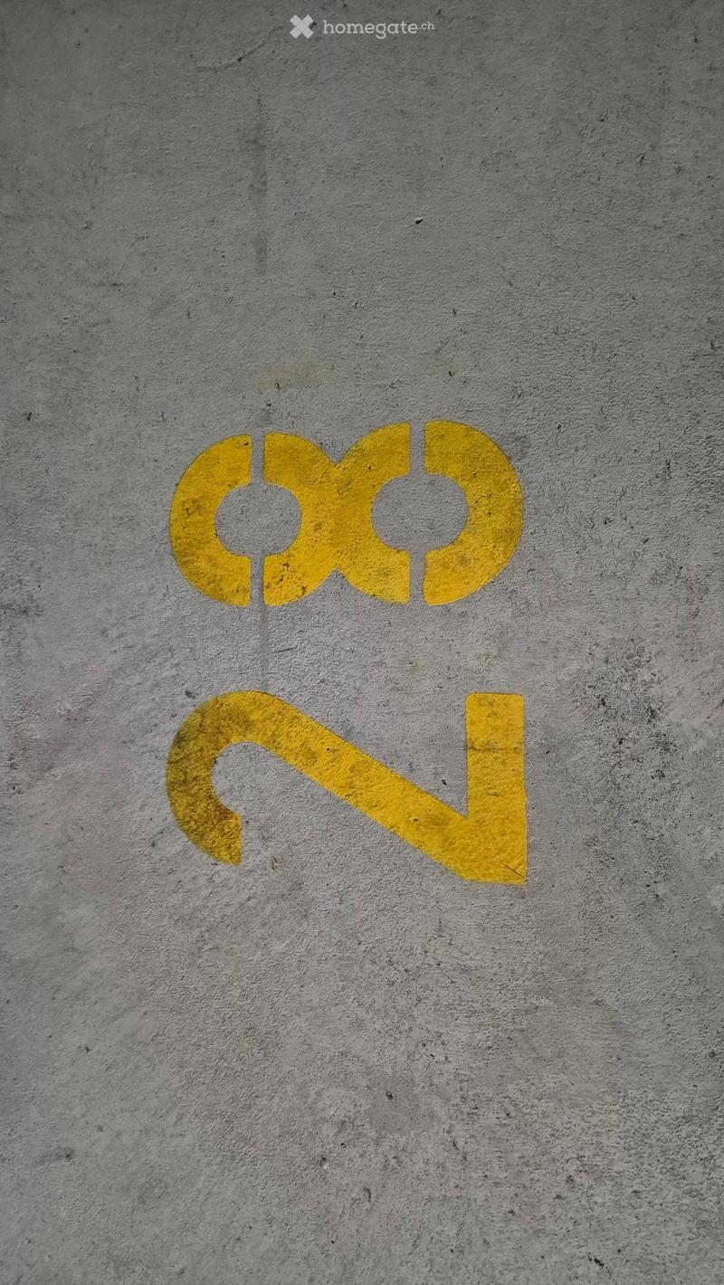 concrete parking area with parking space number 33 painted on the floor