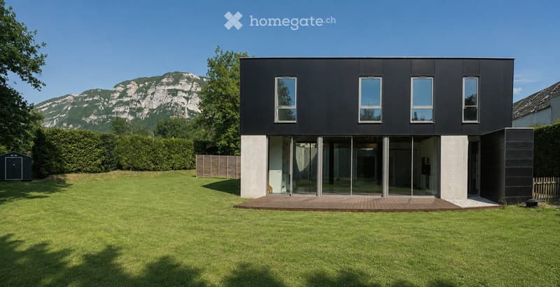 Modern black house with large windows and a wooden deck, set in a grassy yard with a mountain view in the background.