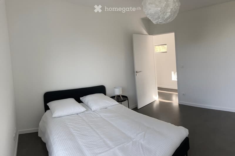 Other. {"visible_features": [],    "type": "Room",    "description": "Bedroom with a bed, two pillows, a nightstand with a lamp, and an open door leading to another room.",    "localized_descriptions":        {        "EN": "Bedroom with a bed, two p