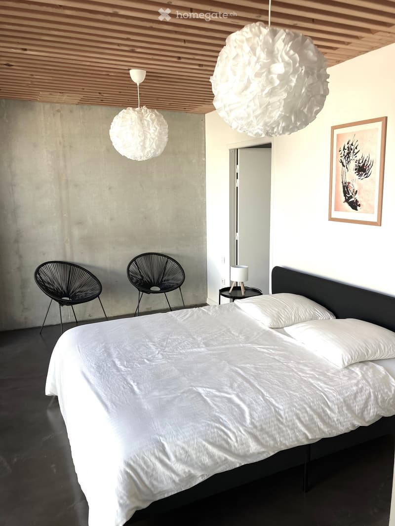 Other. {"visible_features": [],    "type": "Room",    "description": "Bedroom with a bed, two black chairs, a nightstand, and a picture frame on the wall",    "localized_descriptions":        {        "EN": "Bedroom with a bed, two black chairs, a ni