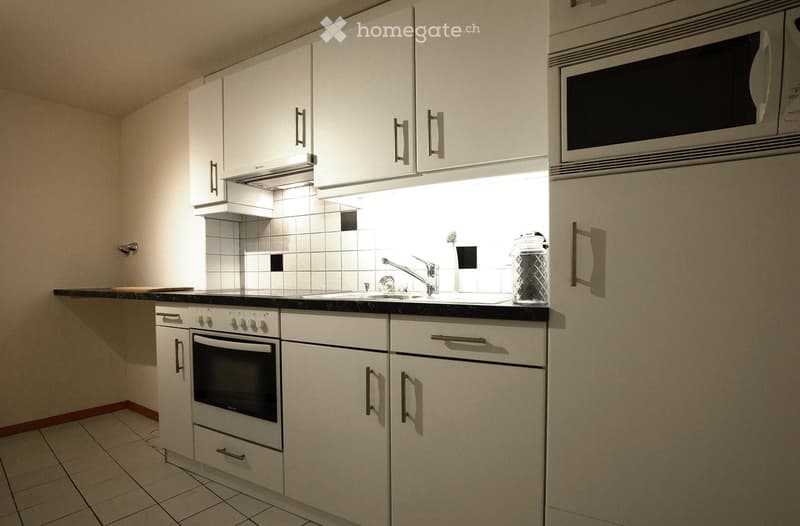 White cabinets, stainless steel appliances, granite countertops, tiled flooring, sink with faucet