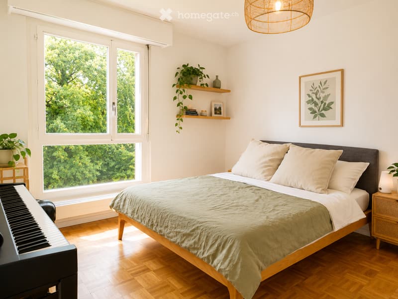 Bright bedroom with large windows, wooden floor, bed with beige bedding, nightstand with lamp, piano, and decorative shelf with plants and books.
